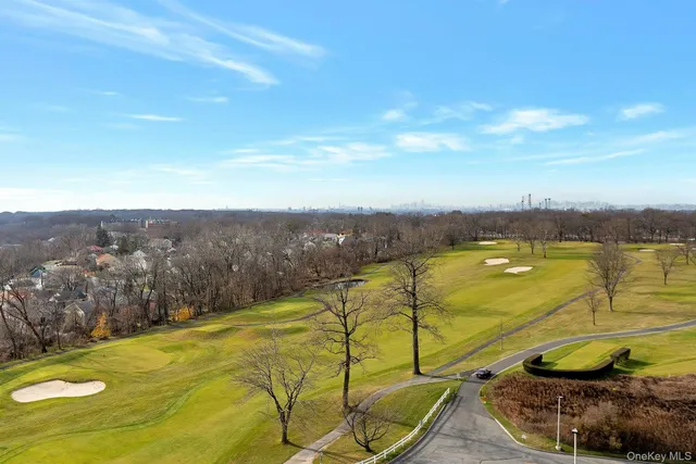 a view of swimming pool with lawn chairs and wooden fence