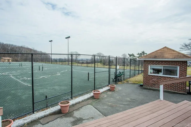 a backyard of a house with fountain table and chairs