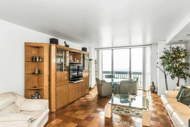 a kitchen with a stove a sink and white cabinets with wooden floor
