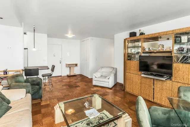 a living room with furniture large windows and a table