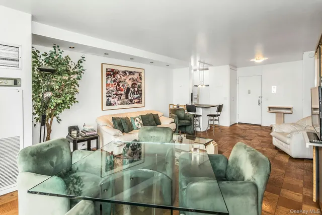 a living room with furniture and a floor to ceiling window