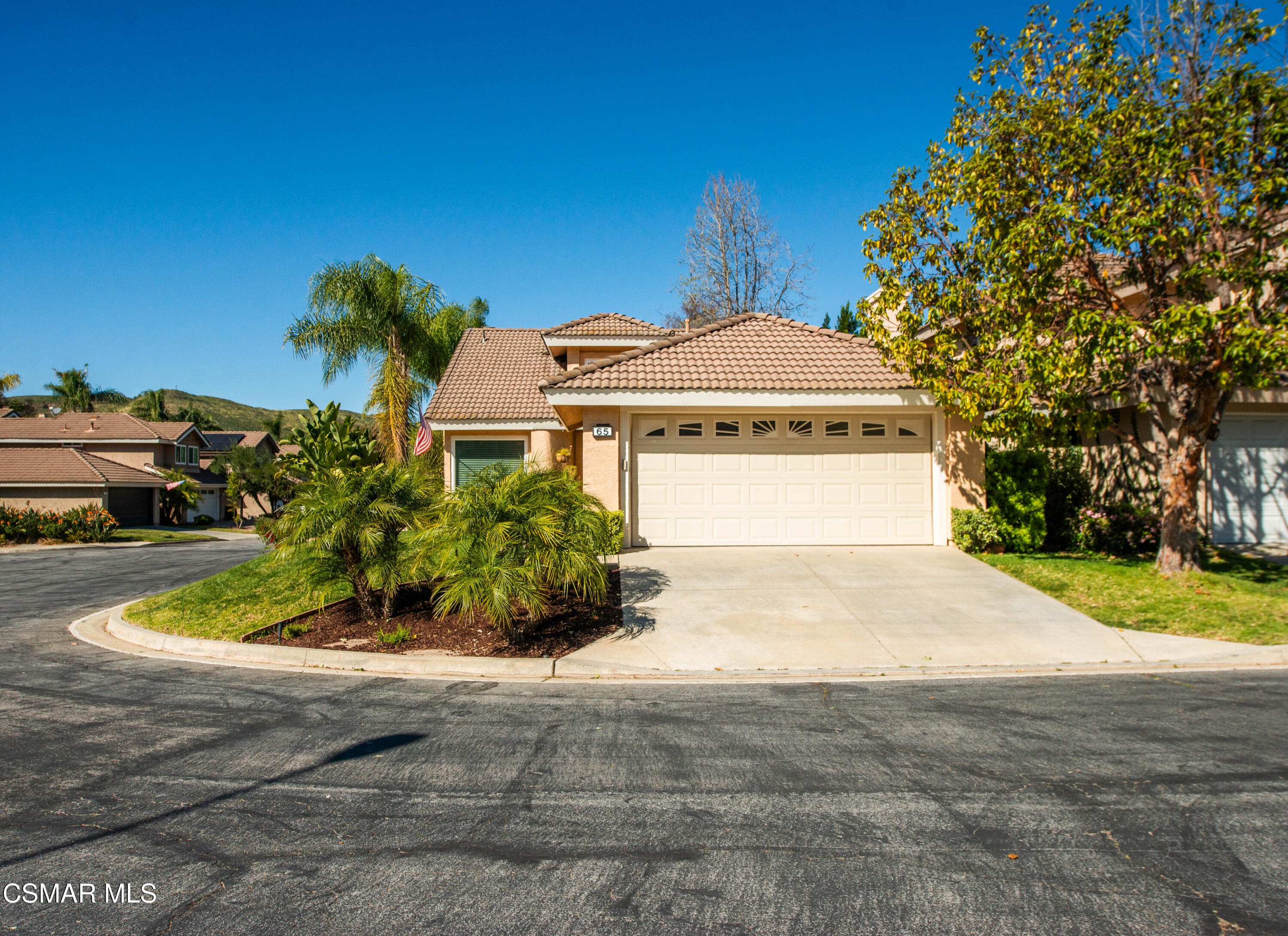 65 Iron Ridge Lane Simi Valley, CA 93065 - Photo 1 of 33 a front view of a house with a yard and garage