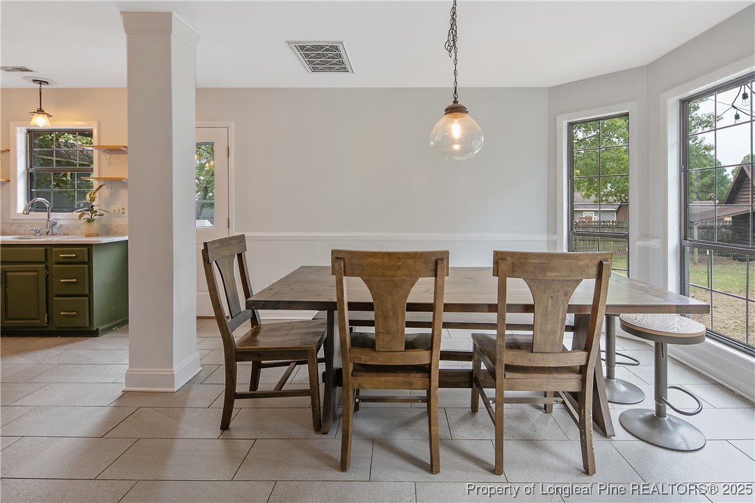64 California Lane Spring Lake, NC 28390 - Photo 14 of 50 a view of a dining room with furniture and a chandelier