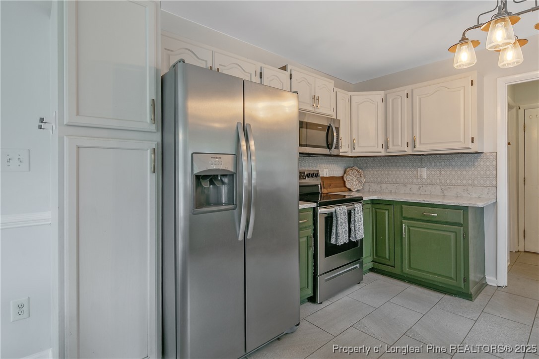 64 California Lane Spring Lake, NC 28390 - Photo 17 of 50 a kitchen with stainless steel appliances granite countertop a refrigerator and a sink