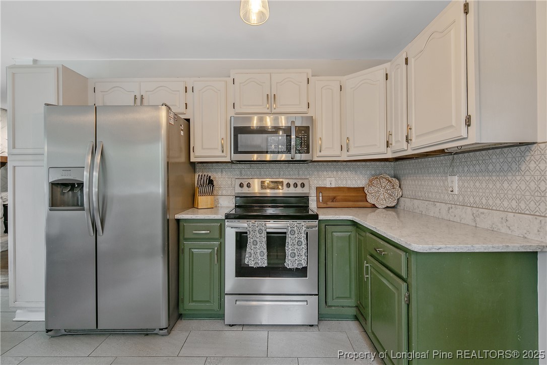 64 California Lane Spring Lake, NC 28390 - Photo 20 of 50 a kitchen with cabinets and stainless steel appliances