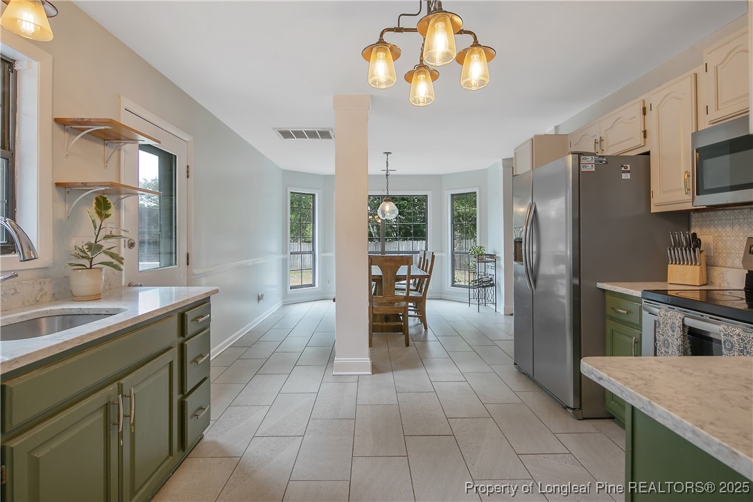 64 California Lane Spring Lake, NC 28390 - Photo 21 of 50 a kitchen with stainless steel appliances granite countertop a refrigerator a sink a stove and oven