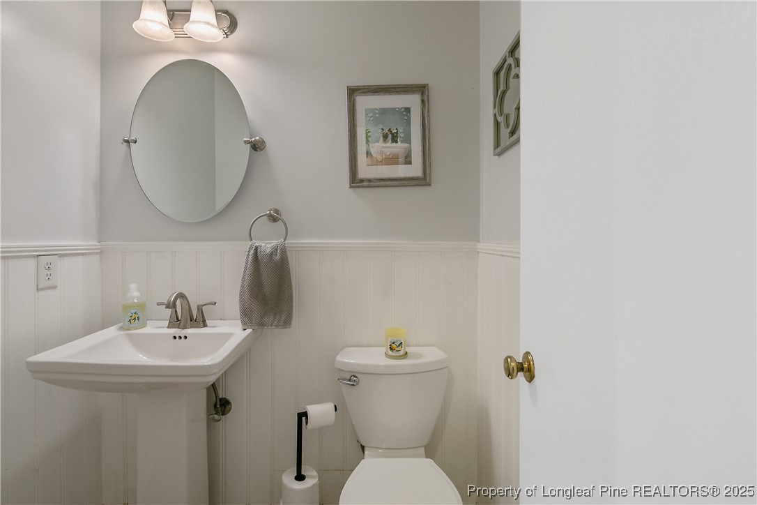 64 California Lane Spring Lake, NC 28390 - Photo 24 of 50 a bathroom with a toilet sink and mirror