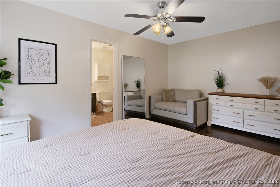 64 California Lane Spring Lake, NC 28390 - Photo 26 of 50 a bedroom with a large bed and a chandelier