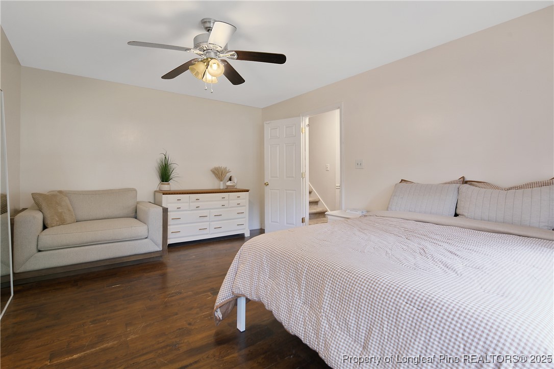 64 California Lane Spring Lake, NC 28390 - Photo 27 of 50 a bedroom with a bed a couch and a chandelier