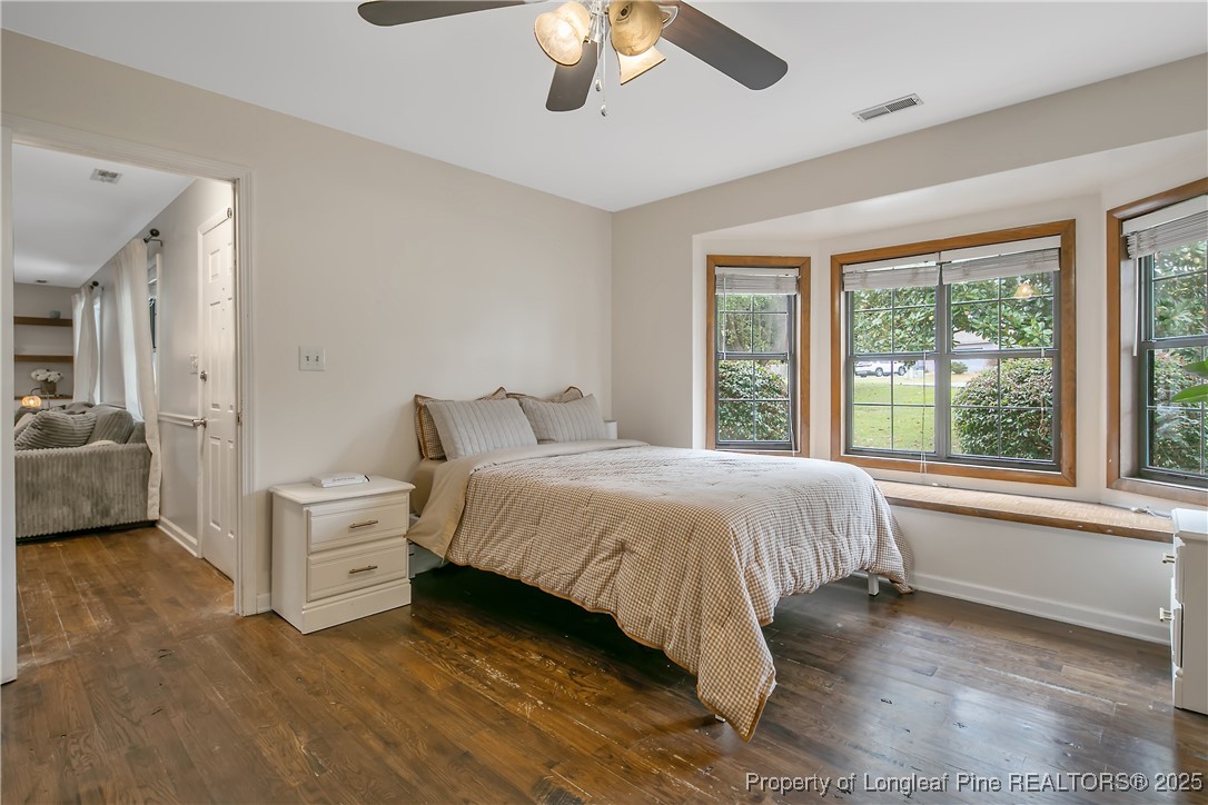 64 California Lane Spring Lake, NC 28390 - Photo 28 of 50 a spacious bedroom with a bed and a chandelier