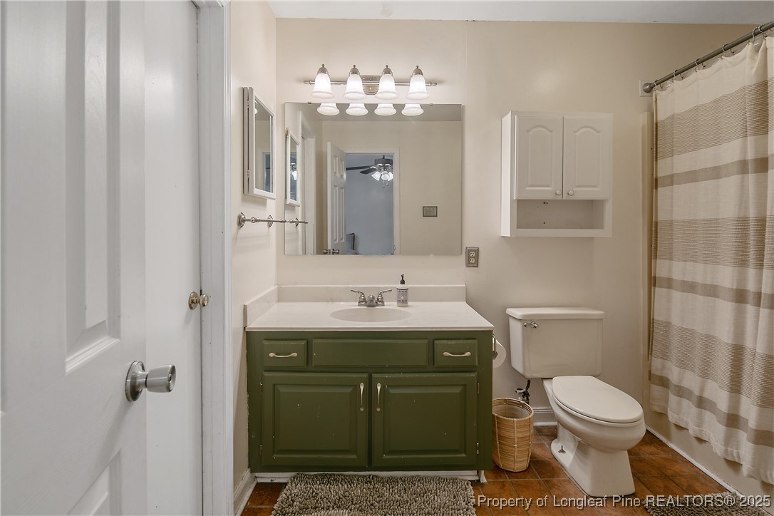 64 California Lane Spring Lake, NC 28390 - Photo 29 of 50 a bathroom with a toilet a sink and mirror