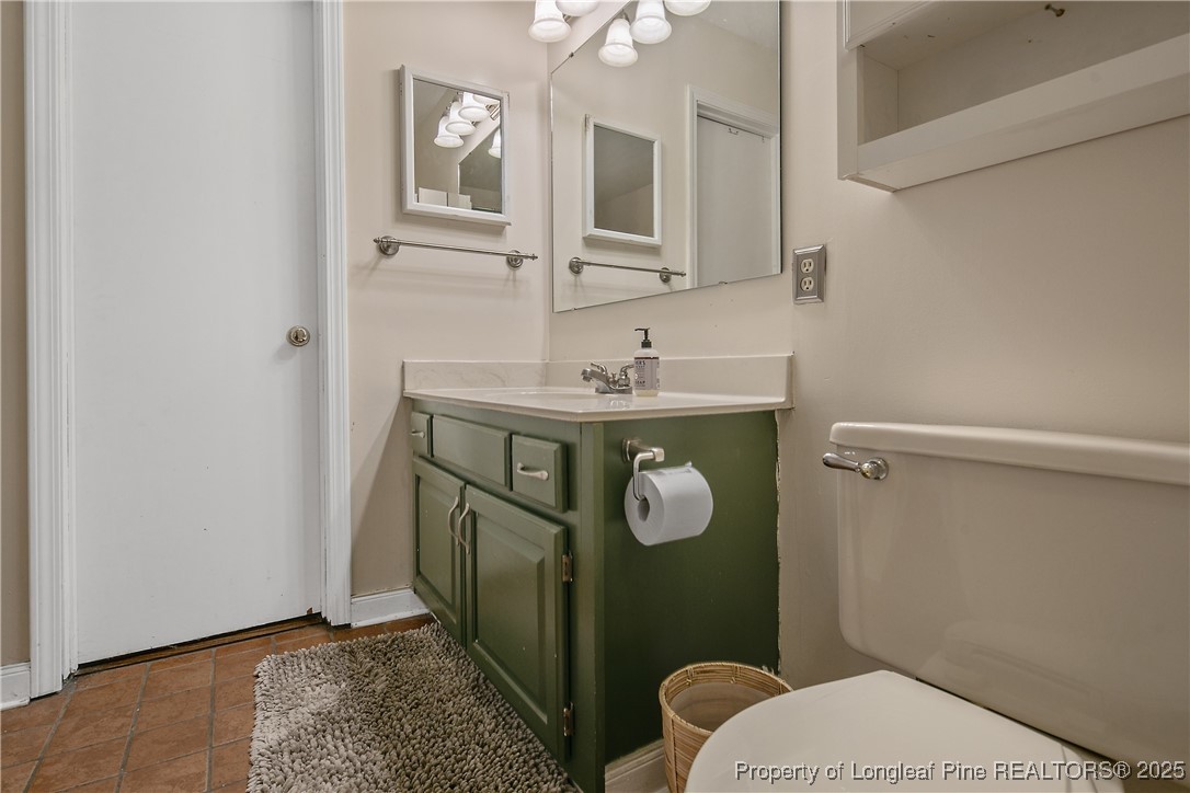 64 California Lane Spring Lake, NC 28390 - Photo 30 of 50 a bathroom with a toilet a sink and mirror
