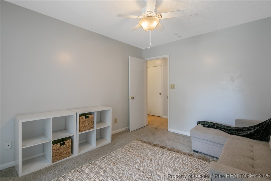 64 California Lane Spring Lake, NC 28390 - Photo 35 of 50 a spacious bedroom with a bed and a chandelier
