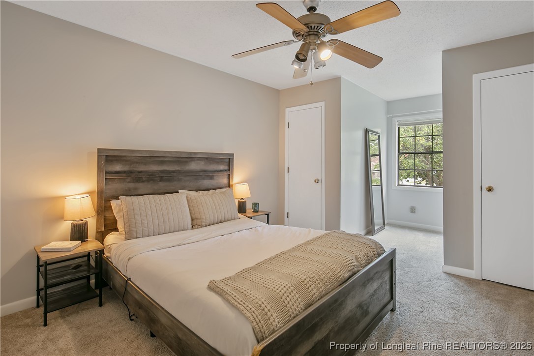 64 California Lane Spring Lake, NC 28390 - Photo 39 of 50 a bedroom with a bed and a chandelier