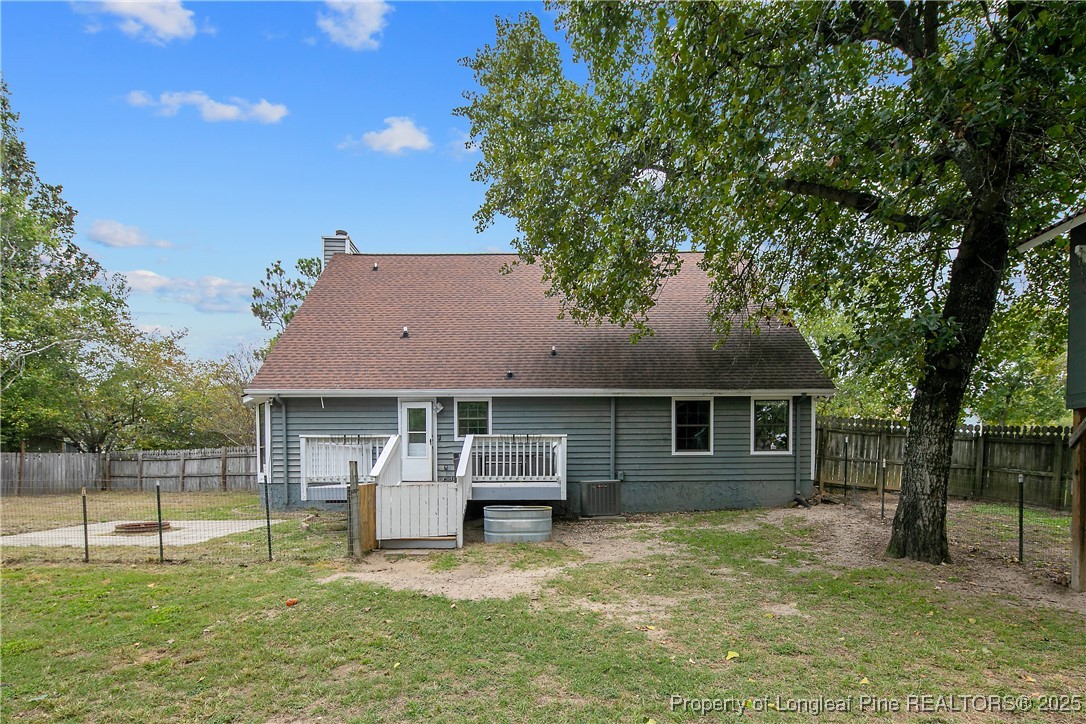 64 California Lane Spring Lake, NC 28390 - Photo 43 of 50 a backyard of a house with yard table and chairs