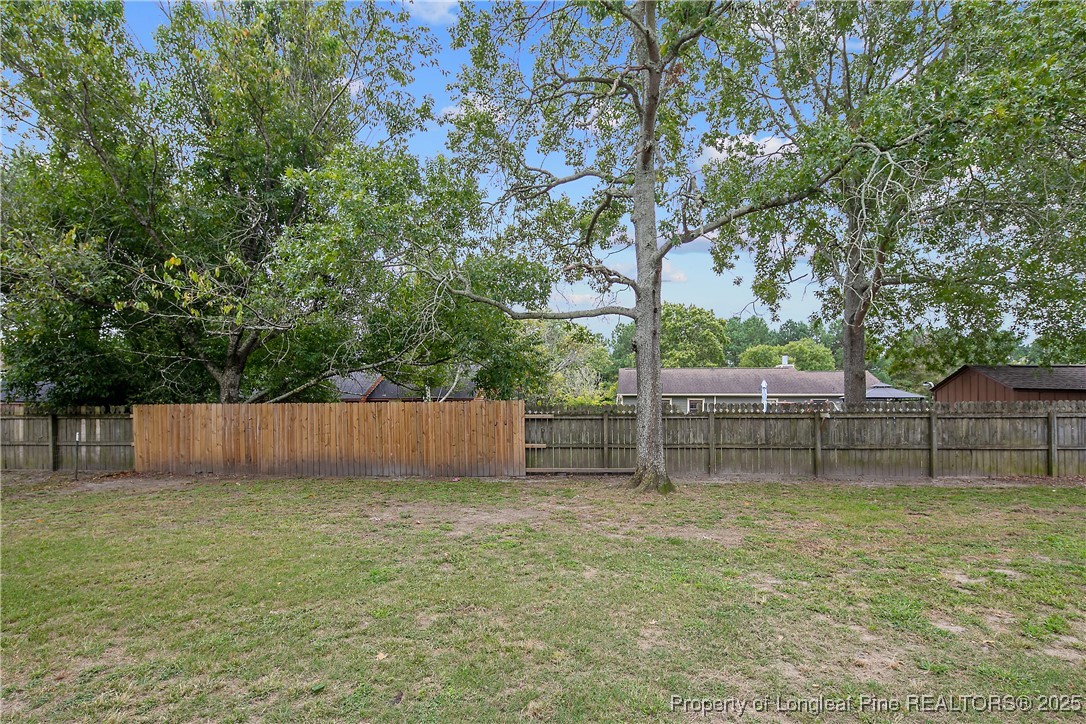 64 California Lane Spring Lake, NC 28390 - Photo 46 of 50 a view of backyard with wooden fence