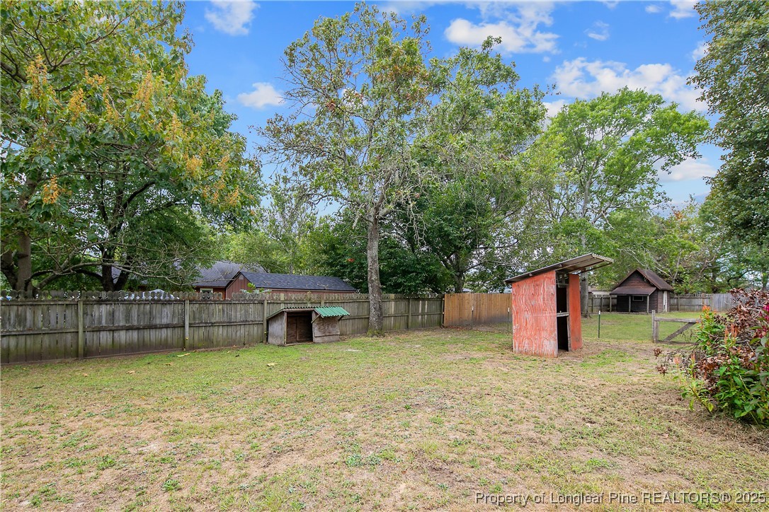 64 California Lane Spring Lake, NC 28390 - Photo 47 of 50 a view of a backyard with a garden and tree