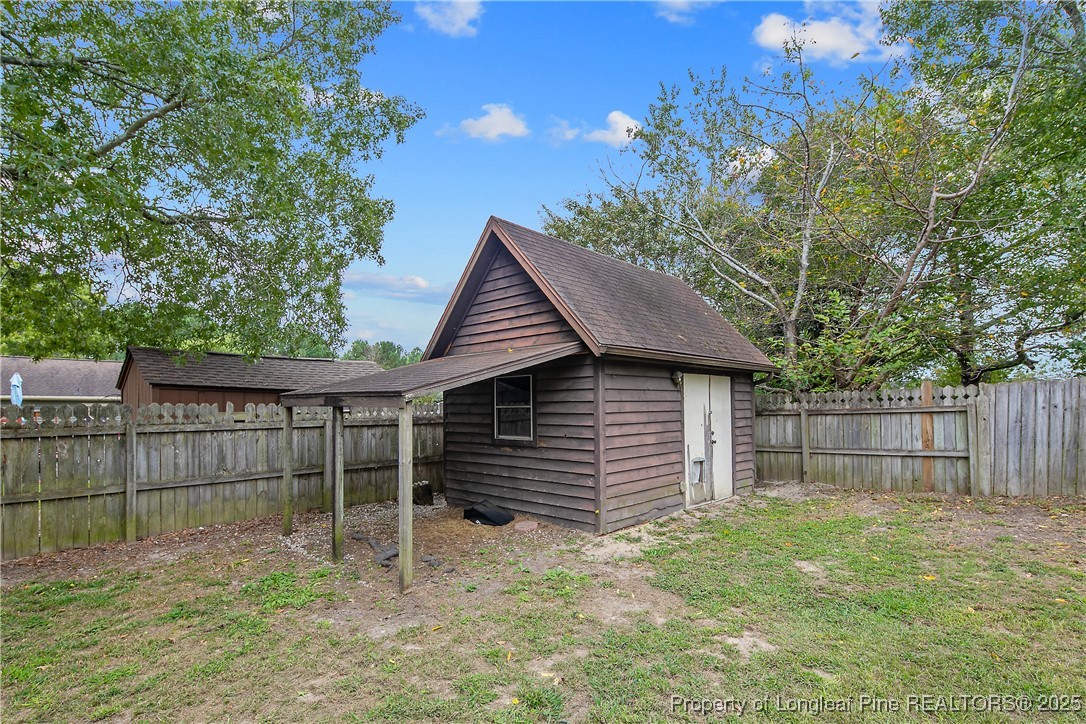 64 California Lane Spring Lake, NC 28390 - Photo 49 of 50 a backyard of a house with plants and tree