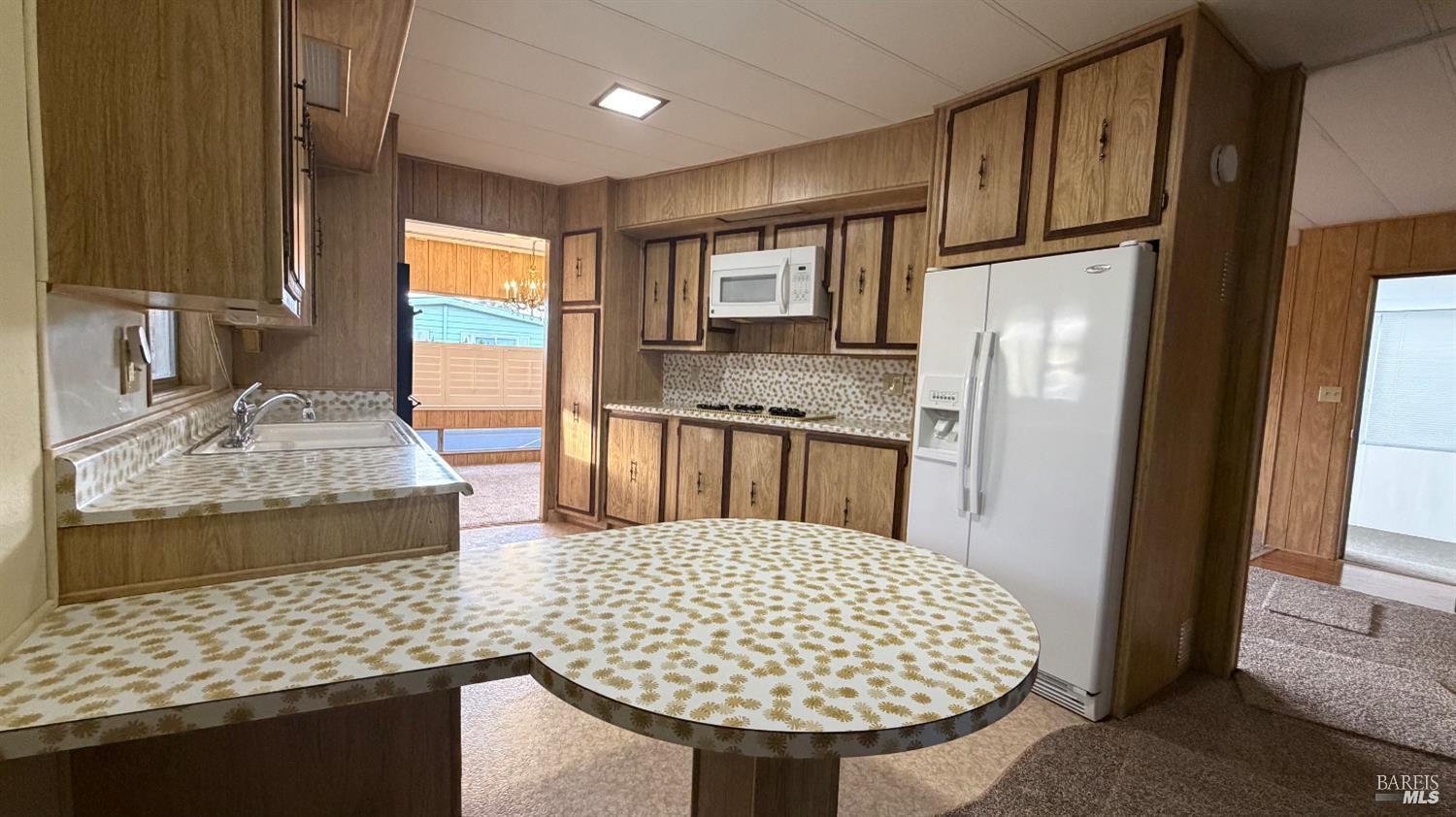 145 Stratford Way Santa Rosa, CA 95401 - Photo 17 of 48 a kitchen with stainless steel appliances granite countertop a sink stove and refrigerator