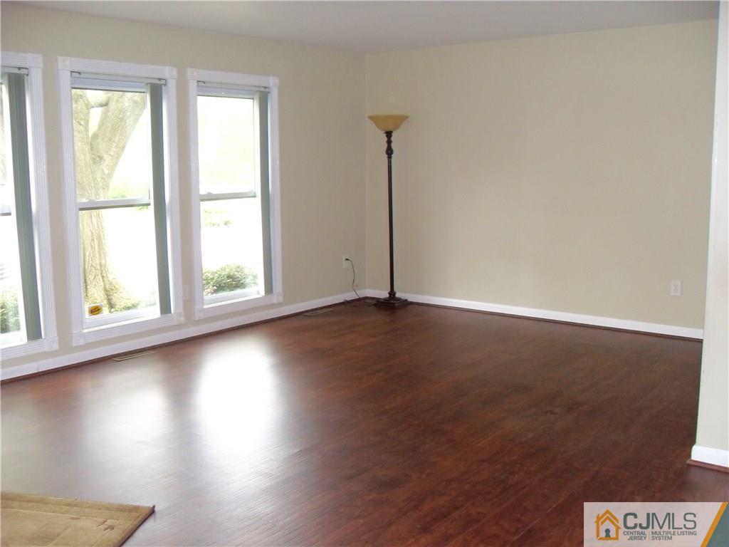 217 Probasco Road East Windsor, NJ 08520 - Photo 4 of 15 an empty room with wooden floor and windows