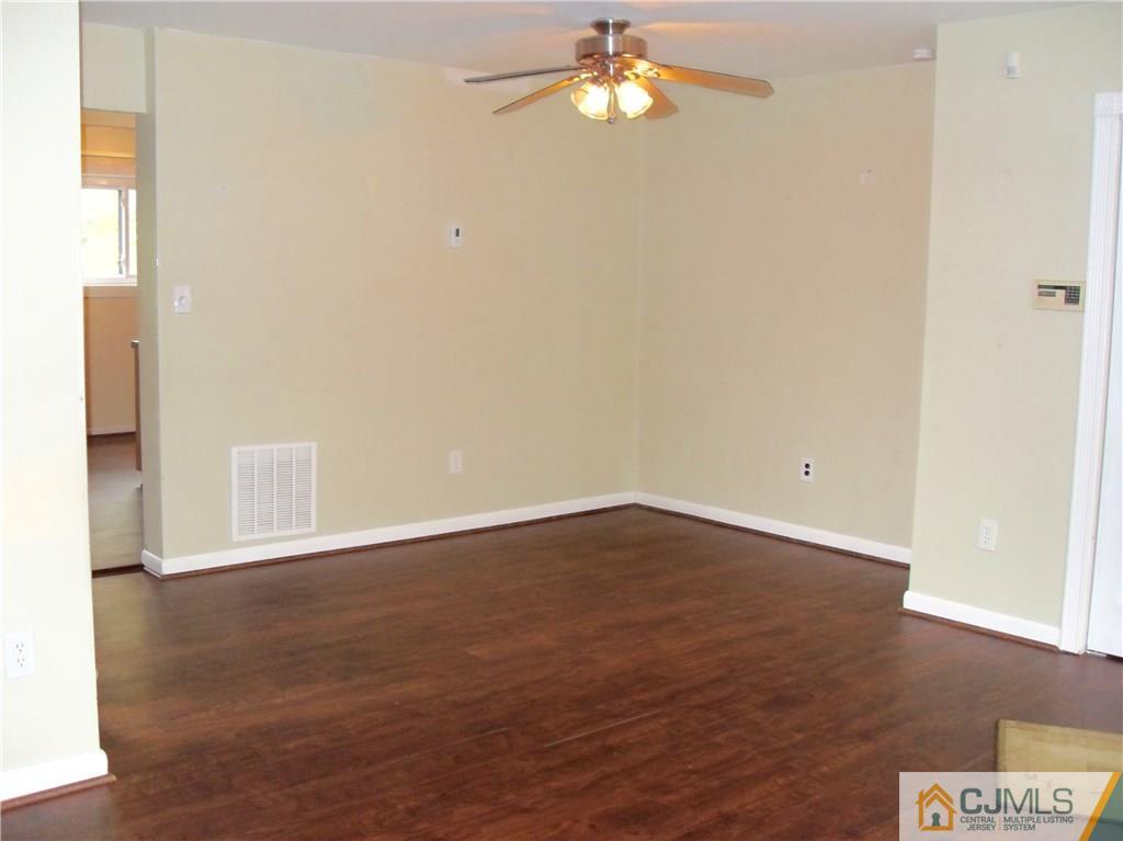 217 Probasco Road East Windsor, NJ 08520 - Photo 5 of 15 an empty room with wooden floor and fan