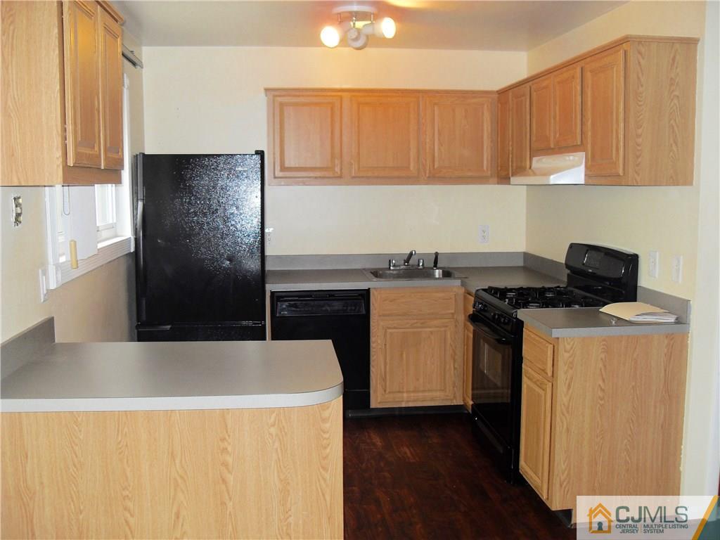 217 Probasco Road East Windsor, NJ 08520 - Photo 6 of 15 a kitchen with a sink a stove and a refrigerator