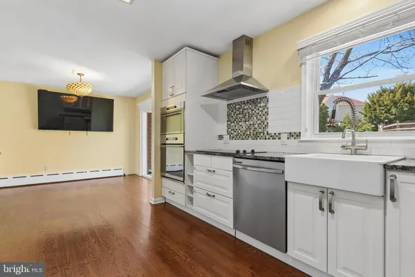 a view of a kitchen with wooden floor and a kitchen