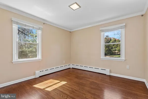 a bedroom with a bed a couch and a window