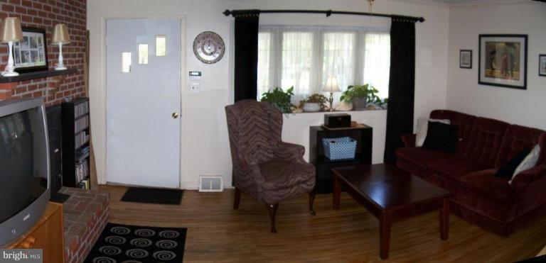 7854 Shellye Road Glen Burnie, MD 21060 - Photo 2 of 22 Living Room with wood floors and wood burning FP