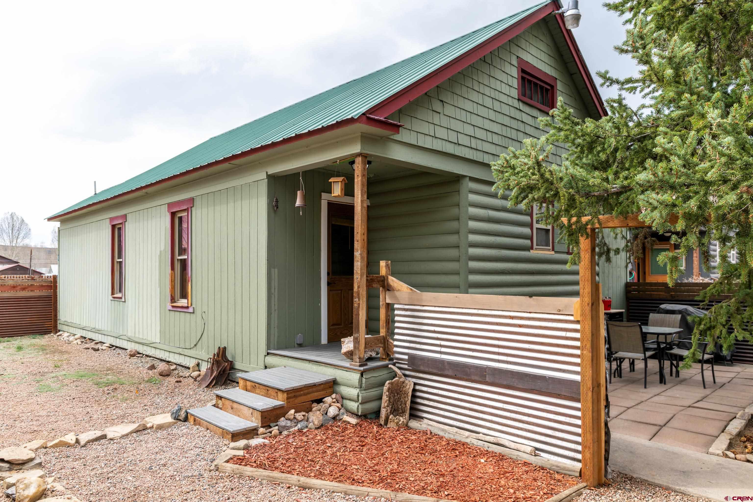 a front view of a house with outdoor seating