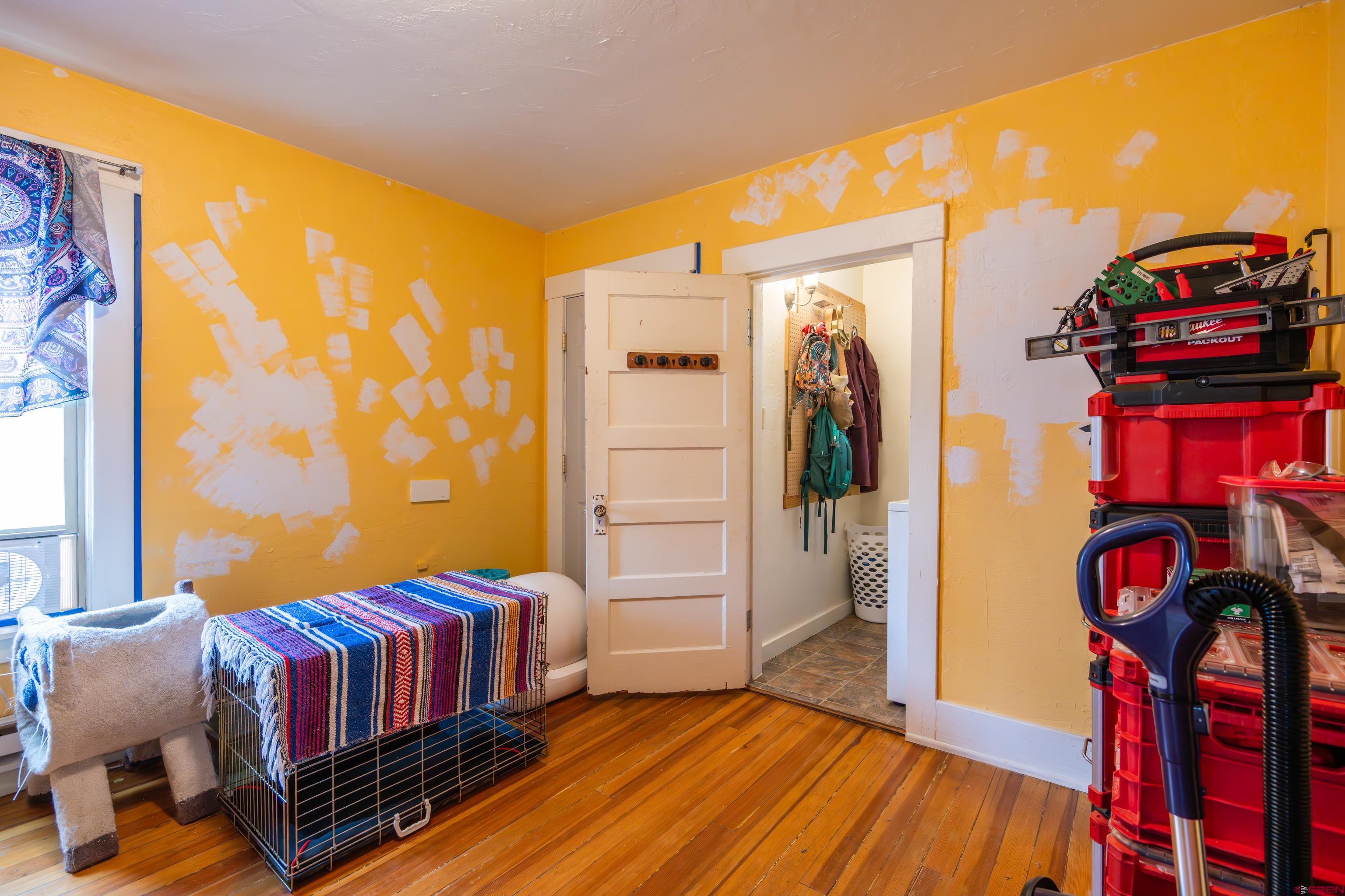 101 North 10th Street, Unit 2 Gunnison, CO 81230 - Photo 12 of 28 a bedroom with a bed and wooden floor