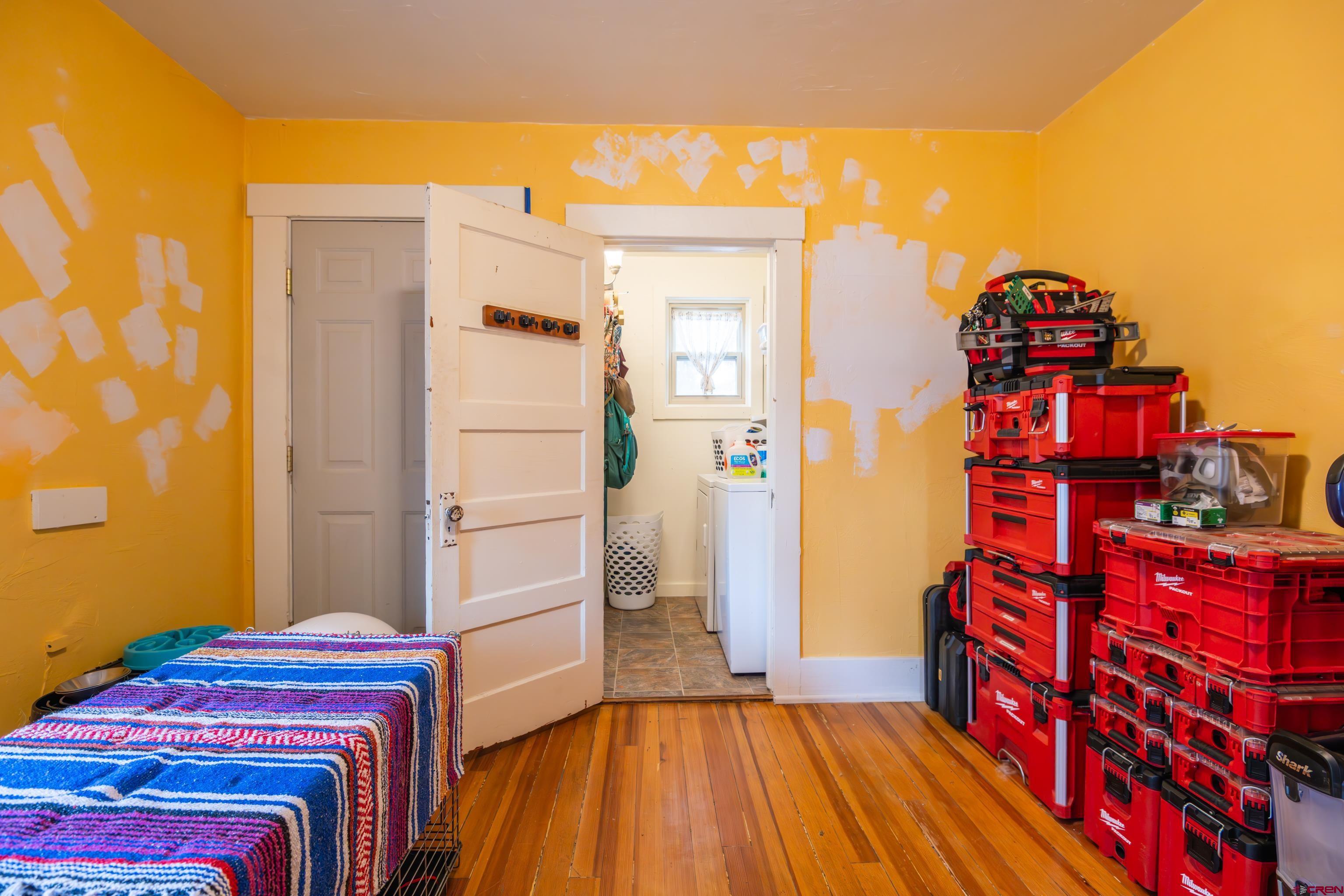 101 North 10th Street, Unit 2 Gunnison, CO 81230 - Photo 13 of 28 a bedroom with a bed and wooden floor