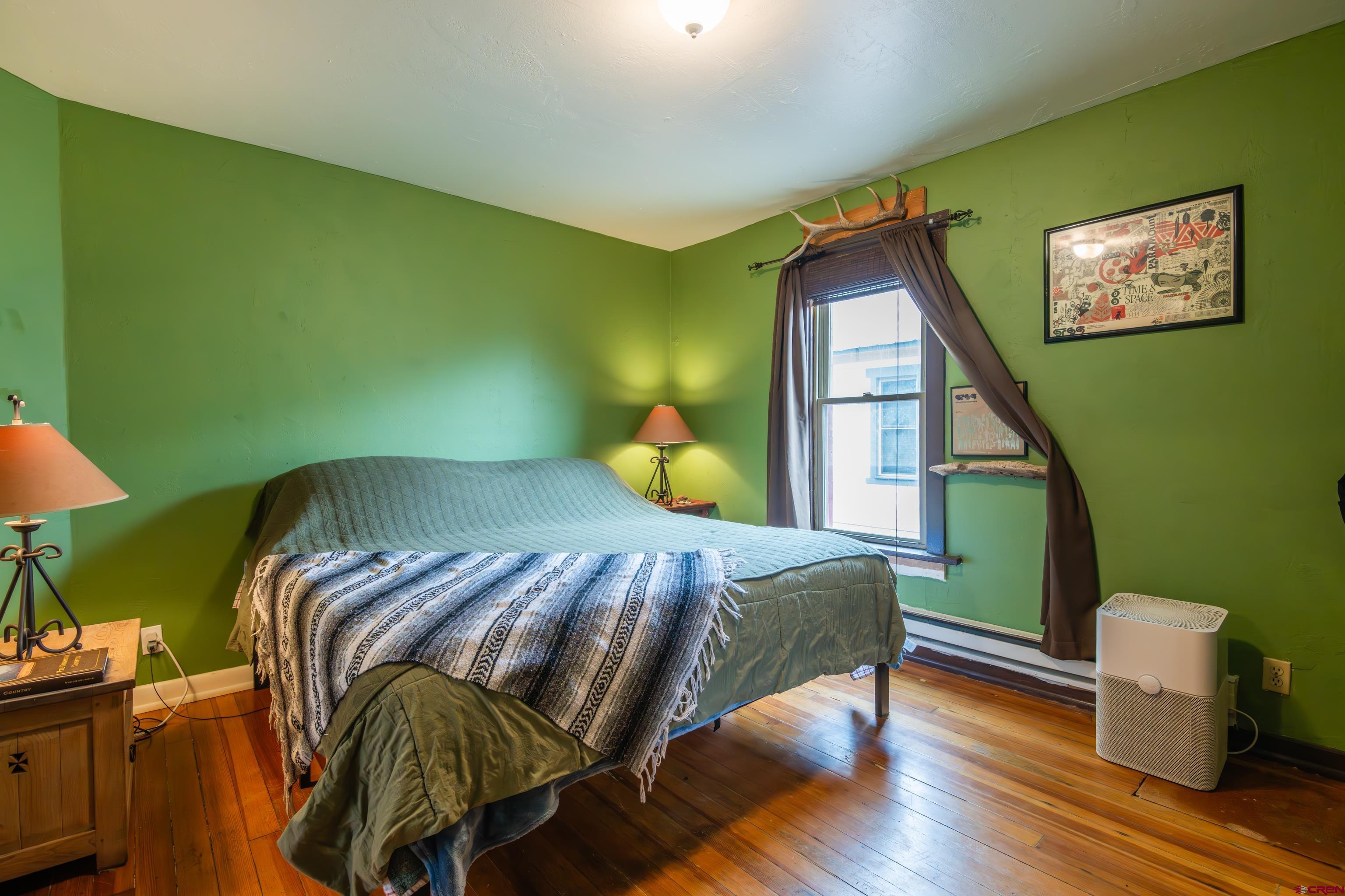 101 North 10th Street, Unit 2 Gunnison, CO 81230 - Photo 21 of 28 a bedroom with a bed and wooden floor