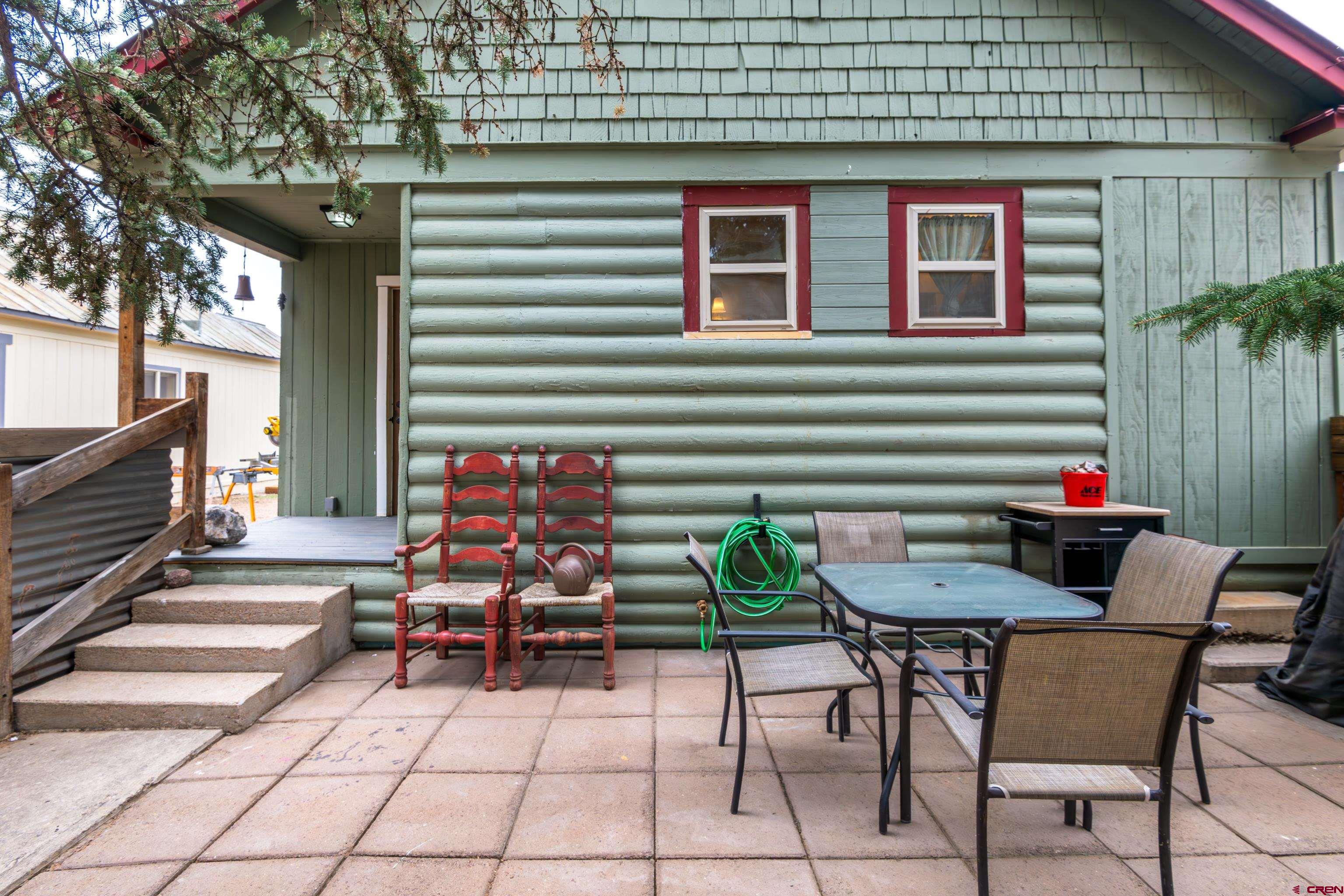 101 North 10th Street, Unit 2 Gunnison, CO 81230 - Photo 5 of 28 a backyard of a house with barbeque oven table and chairs