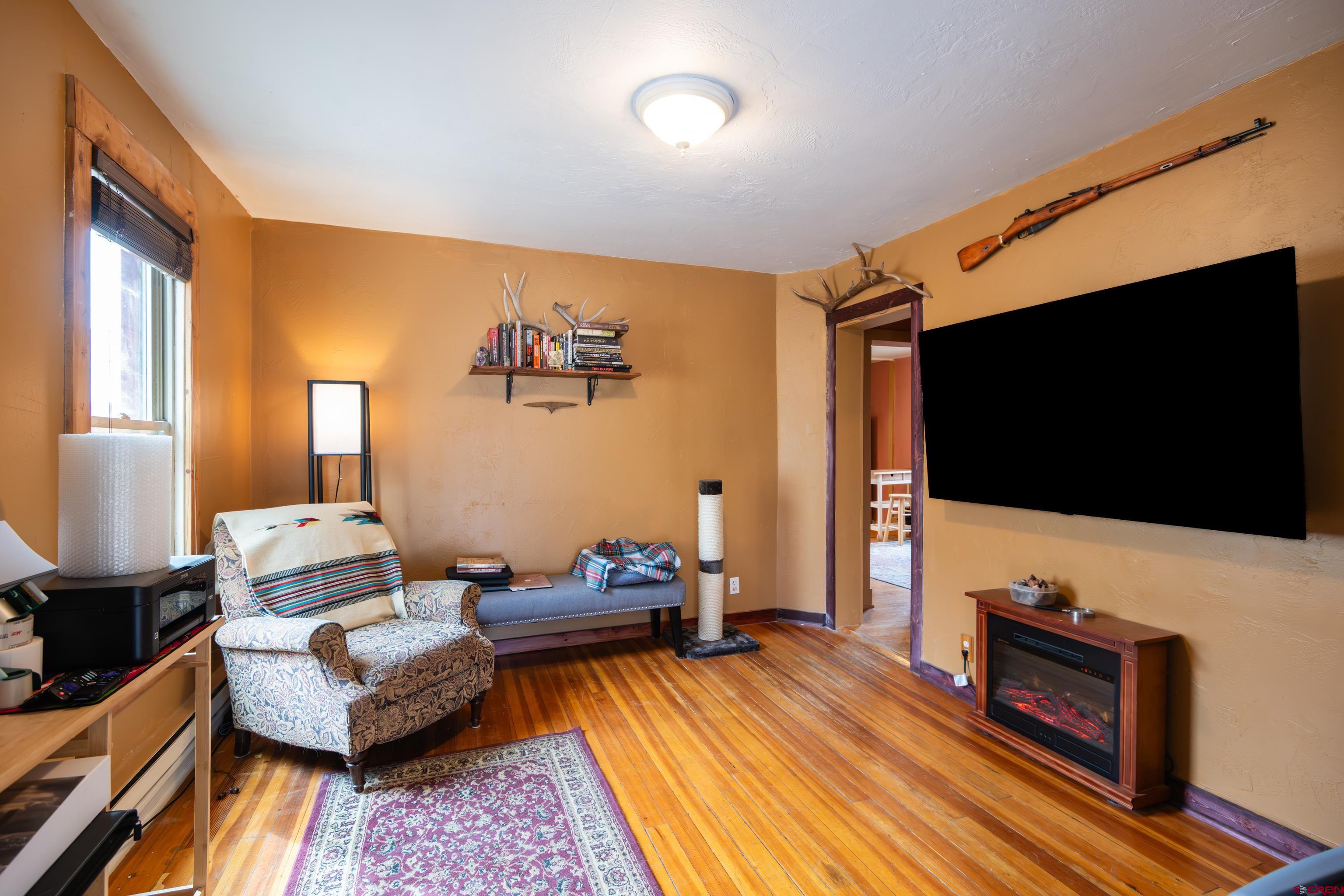 101 North 10th Street, Unit 2 Gunnison, CO 81230 - Photo 6 of 28 a living room with furniture and a flat screen tv