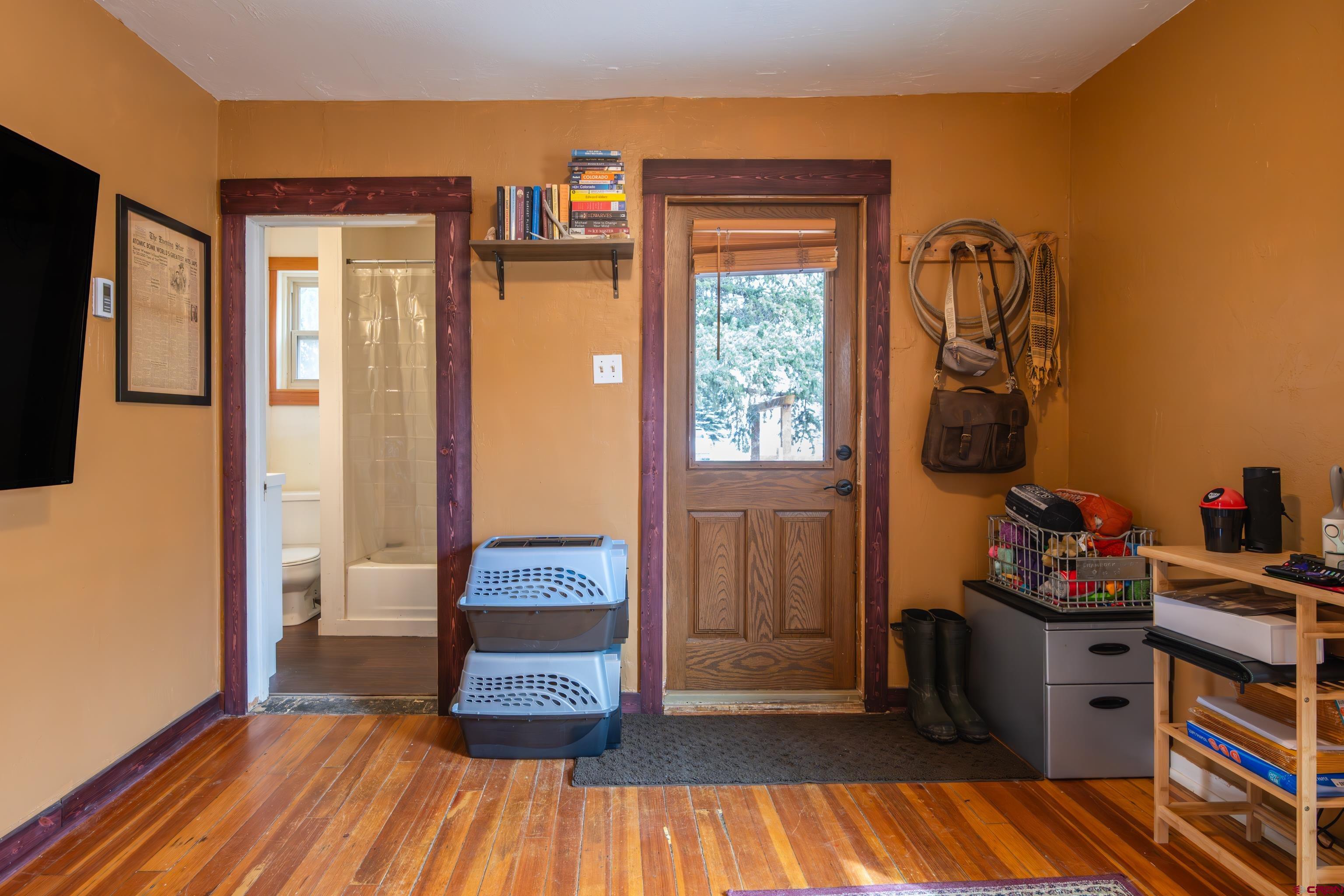 101 North 10th Street, Unit 2 Gunnison, CO 81230 - Photo 8 of 28 a bedroom with a bed and wooden floor