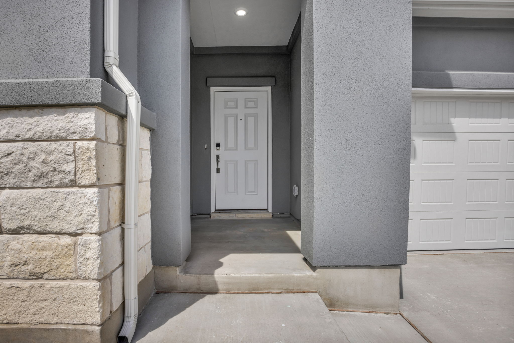 131 Adeline Road Hutto, TX 78634 - Photo 4 of 30 A welcoming front entry features light stone accents and a classic panel door, promising inviting interiors.