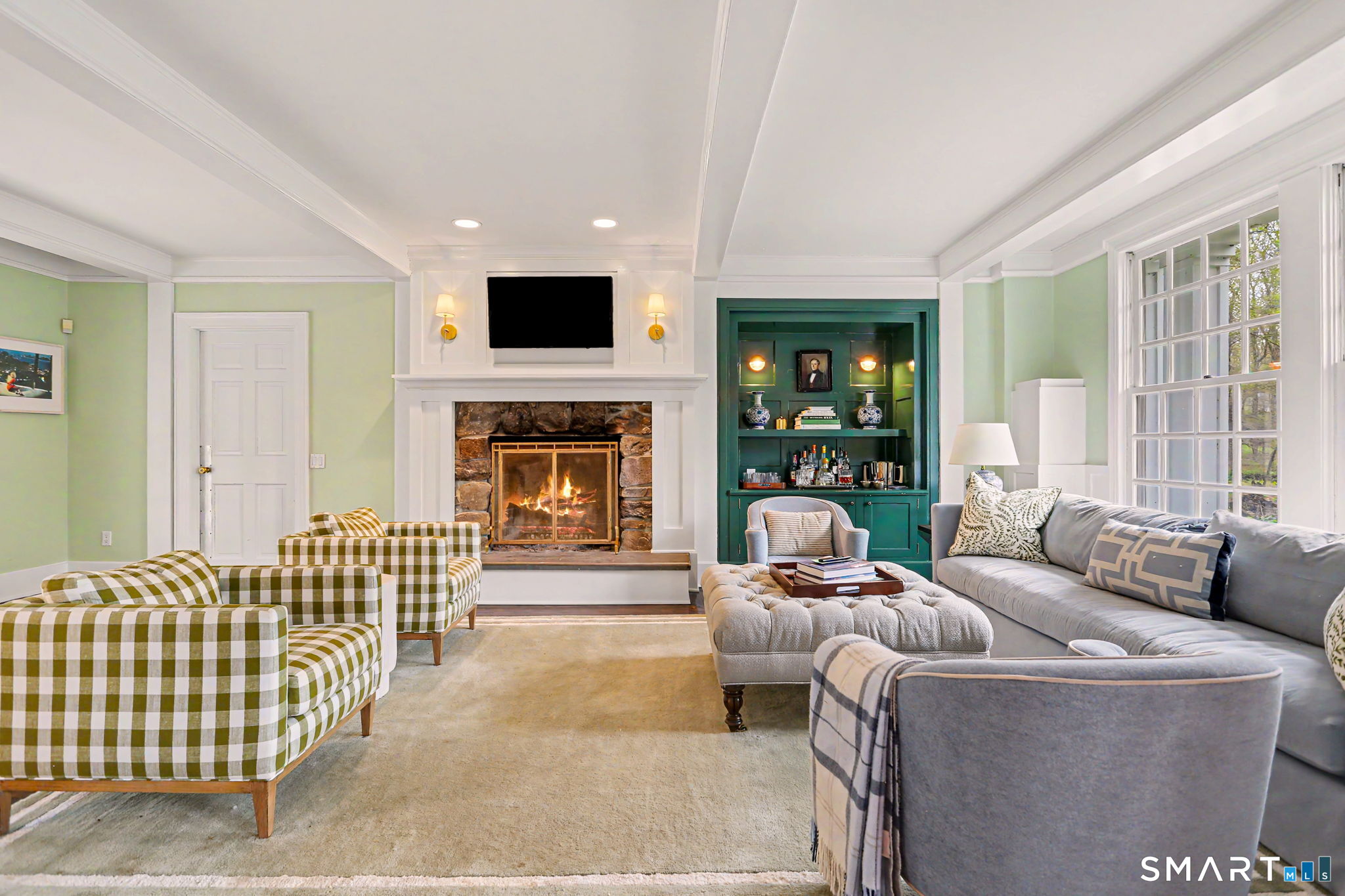 66 Gate Stone Lane Fairfield, CT 06824 - Photo 13 of 39 Family room with paneled fireplace and built in dry bar