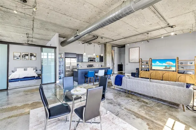 a living room with lots of furniture and kitchen view
