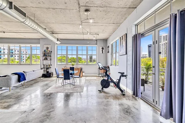 a very nice looking room with a large window and furniture