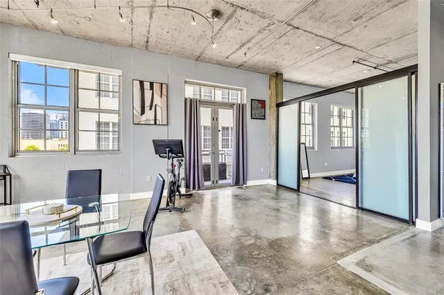 a view of a livingroom with furniture wooden floor and windows