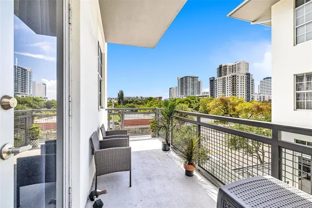 a balcony with furniture and a potted plant