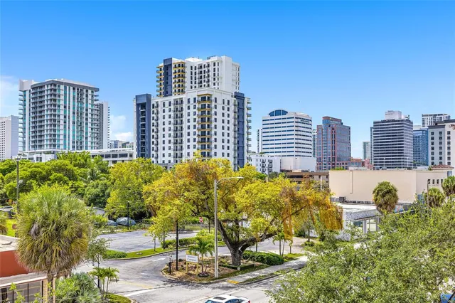 a view of a livingroom with wooden furniture and windows