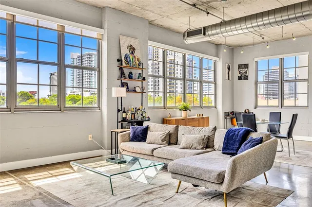 a living room with furniture and large windows