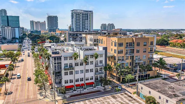 a view of a rooftop with chairs and a table
