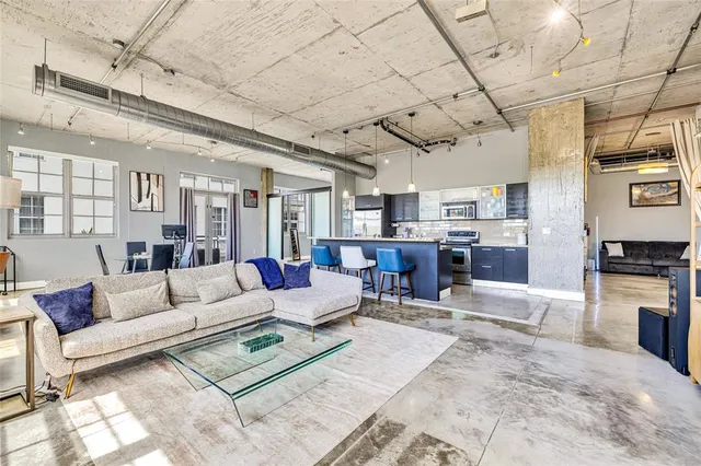 a living room with furniture and kitchen view