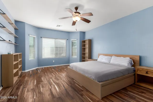 a bedroom with a large bed and a chandelier