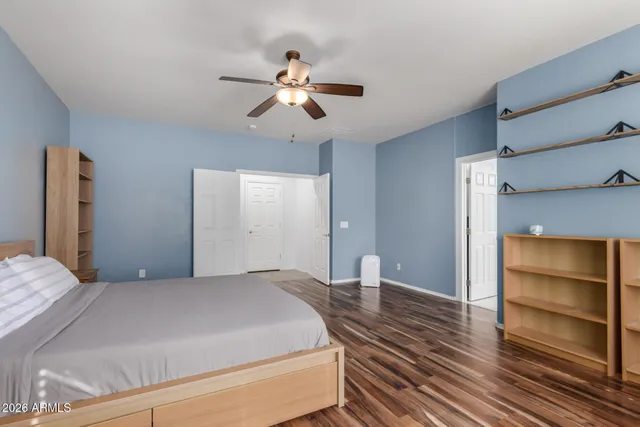 a bedroom with a bed and cabinets