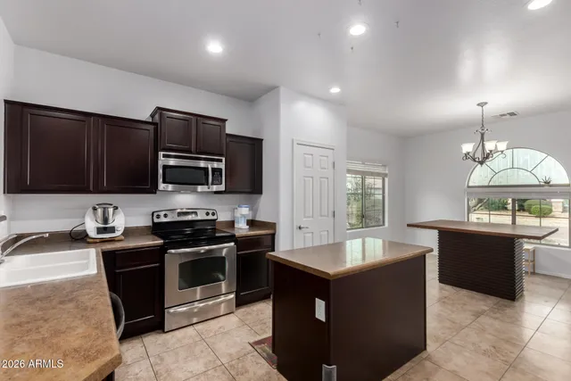 a large kitchen with stainless steel appliances granite countertop a sink and a stove