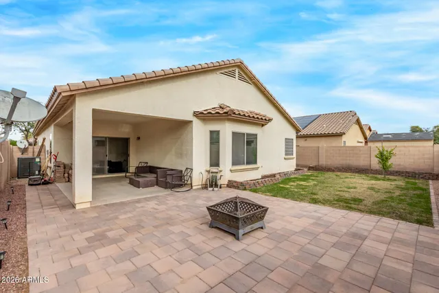 a view of a house with backyard and sitting area